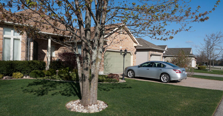 House with a gray car in the driveway